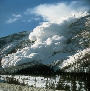 An avalanche going down a mountain.